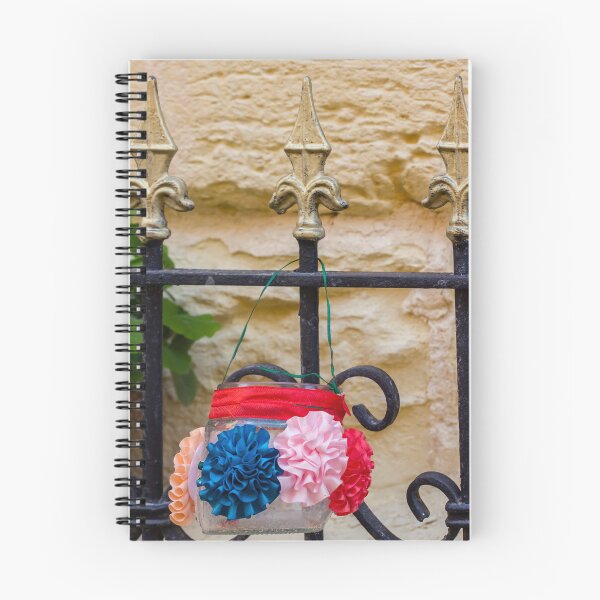 Item preview, Decorative Hanging Jar With Fabric Flowers on Iron Fence Near Stone Wall designed and sold by Nmallia.