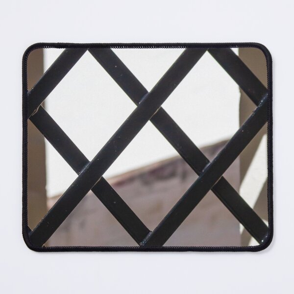 Item preview, Black Metal Lattice Fence With Diamond Pattern Framing Bright Urban Building And Blue Sky Background designed and sold by Nmallia.