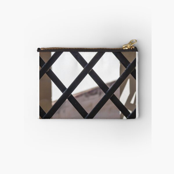Item preview, Black Metal Lattice Fence With Diamond Pattern Framing Bright Urban Building And Blue Sky Background designed and sold by Nmallia.