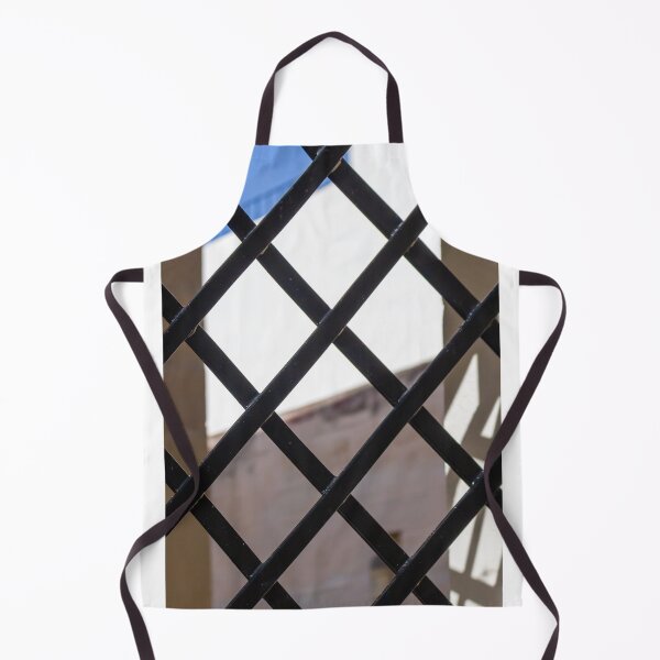 Item preview, Black Metal Lattice Fence With Diamond Pattern Framing Bright Urban Building And Blue Sky Background designed and sold by Nmallia.