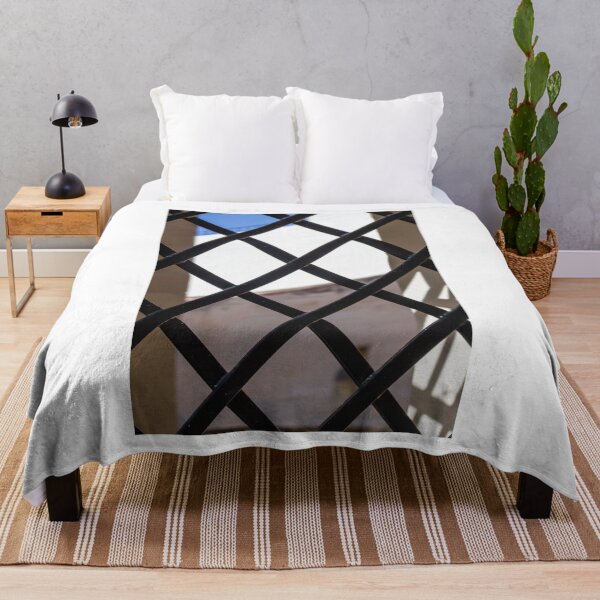 Item preview, Black Metal Lattice Fence With Diamond Pattern Framing Bright Urban Building And Blue Sky Background designed and sold by Nmallia.