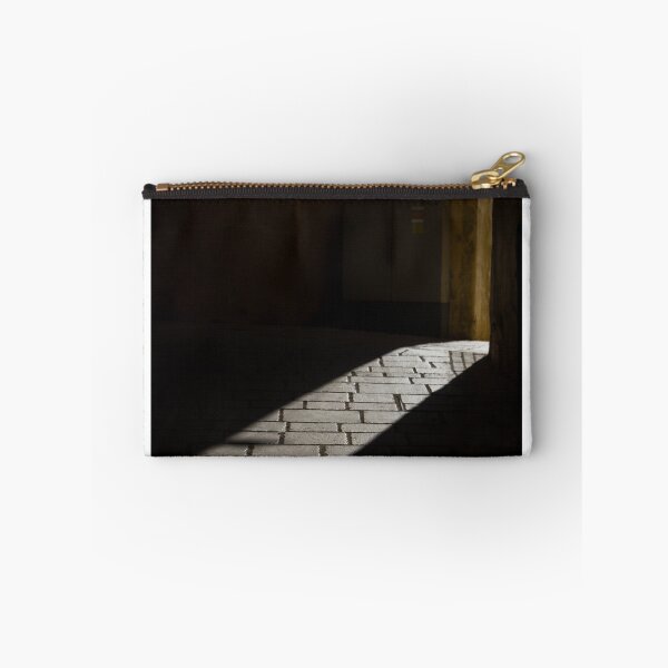 Item preview, Diagonal Sunlight on Cobblestone Alleyway Casting Dramatic Shadow in Narrow Urban Passage designed and sold by Nmallia.