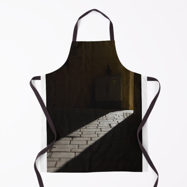 Item preview, Diagonal Sunlight on Cobblestone Alleyway Casting Dramatic Shadow in Narrow Urban Passage designed and sold by Nmallia.