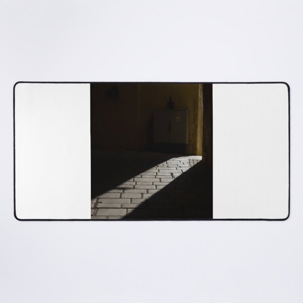 Item preview, Diagonal Sunlight on Cobblestone Alleyway Casting Dramatic Shadow in Narrow Urban Passage designed and sold by Nmallia.