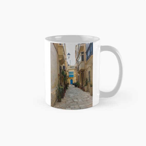 Item preview, Sunlit Narrow Mediterranean Alley With Blue Door, Stone Pavement, Potted Plants And Traditional Balconies designed and sold by Nmallia.
