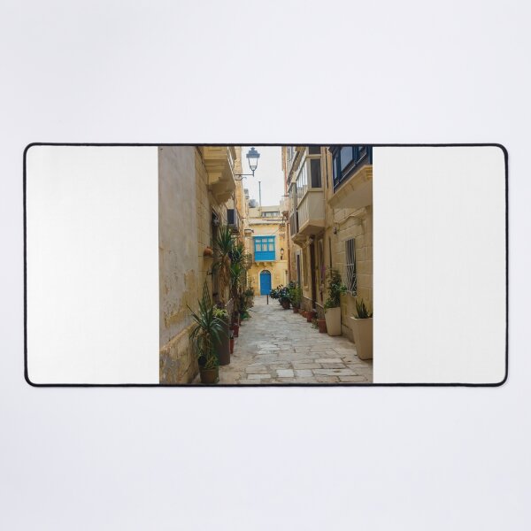 Item preview, Sunlit Narrow Mediterranean Alley With Blue Door, Stone Pavement, Potted Plants And Traditional Balconies designed and sold by Nmallia.
