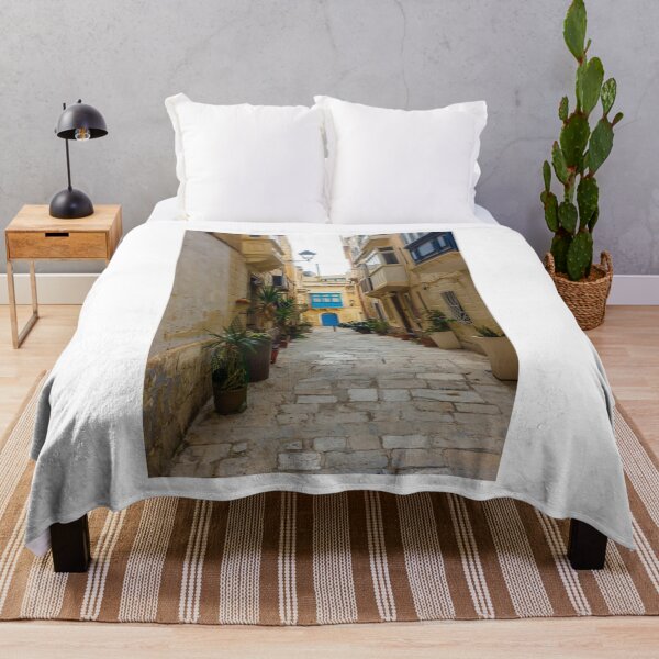 Item preview, Sunlit Narrow Mediterranean Alley With Blue Door, Stone Pavement, Potted Plants And Traditional Balconies designed and sold by Nmallia.