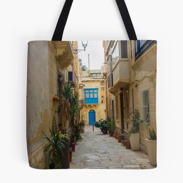 Item preview, Sunlit Narrow Mediterranean Alley With Blue Door, Stone Pavement, Potted Plants And Traditional Balconies designed and sold by Nmallia.