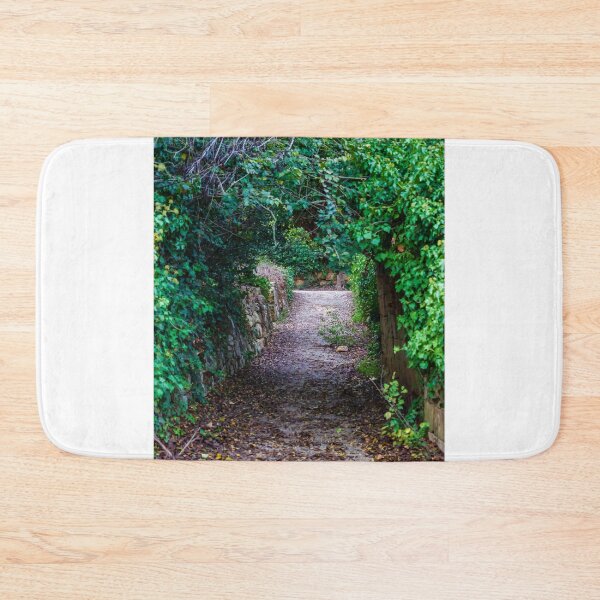 Item preview, Secluded Ivy-Covered Garden Pathway Framed by Stone Walls and Lush Green Archway designed and sold by Nmallia.