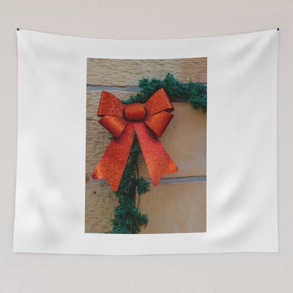 Item preview, Sparkling Red Bow Christmas Decoration On Green Garland Against Stone Wall For Holiday Display designed and sold by Nmallia.