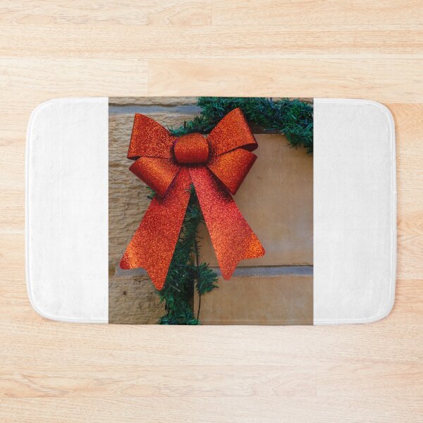 Item preview, Sparkling Red Bow Christmas Decoration On Green Garland Against Stone Wall For Holiday Display designed and sold by Nmallia.