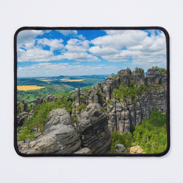 Item preview, Picturesque view of the Schrammsteine rock formations and the Falkenstein in the Saxon Switzerland National Park under a blue sky. designed and sold by Marc Alexander Kunze.