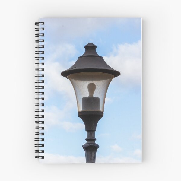 Item preview, Vintage Street Lamp Lantern With Bulb Against Blue Sky And Soft White Clouds designed and sold by Nmallia.