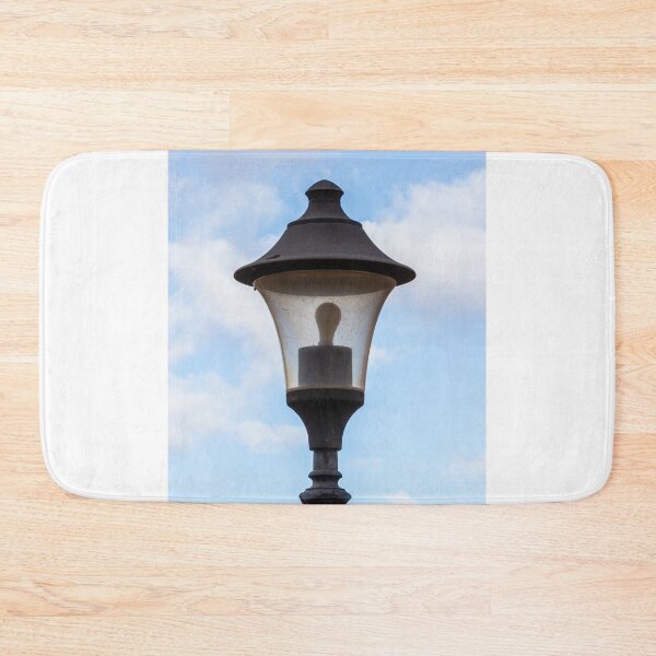 Item preview, Vintage Street Lamp Lantern With Bulb Against Blue Sky And Soft White Clouds designed and sold by Nmallia.