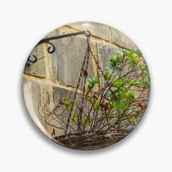 Item preview, Rustic Hanging Basket With Green Plants Against Weathered Stone Wall In Outdoor Decor designed and sold by Nmallia.