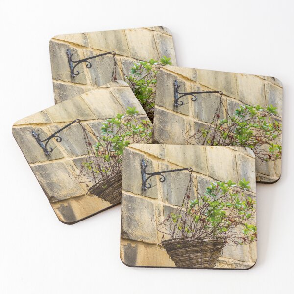 Item preview, Rustic Hanging Basket With Green Plants Against Weathered Stone Wall In Outdoor Decor designed and sold by Nmallia.