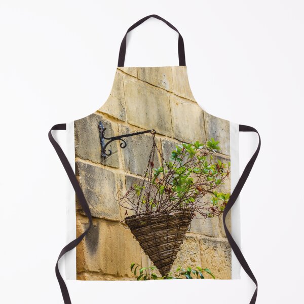 Item preview, Rustic Hanging Basket With Green Plants Against Weathered Stone Wall In Outdoor Decor designed and sold by Nmallia.