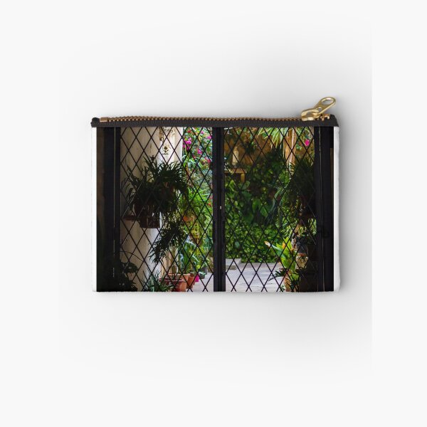 Item preview, Wrought Iron Gate Framing Sunlit Courtyard Garden With Potted Plants And Lush Foliage designed and sold by Nmallia.