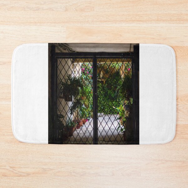 Item preview, Wrought Iron Gate Framing Sunlit Courtyard Garden With Potted Plants And Lush Foliage designed and sold by Nmallia.