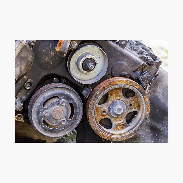 Item preview, Close-Up Of Rusty Engine Pulleys And Worn Belts On Old Automotive Mechanical Part designed and sold by Nmallia.