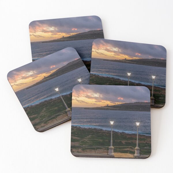 Item preview, Coastal Sunset Over Rocky Shoreline With Lit Lampposts and Distant Headland at Dusk designed and sold by Nmallia.