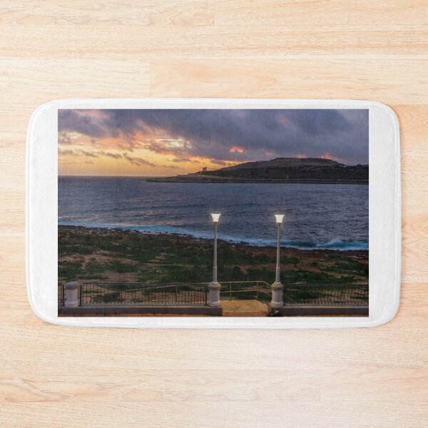 Item preview, Coastal Sunset Over Rocky Shoreline With Lit Lampposts and Distant Headland at Dusk designed and sold by Nmallia.