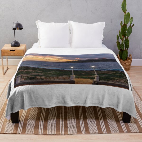 Item preview, Coastal Sunset Over Rocky Shoreline With Lit Lampposts and Distant Headland at Dusk designed and sold by Nmallia.