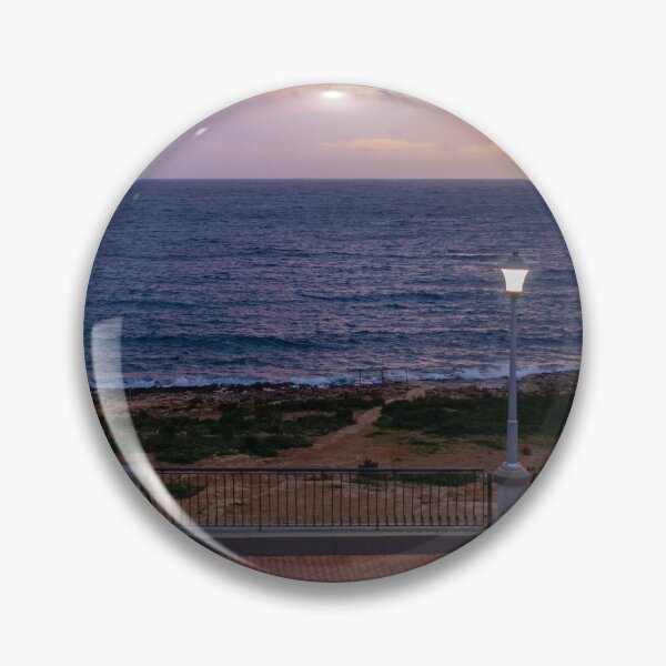 Item preview, Coastal Sunset Over Rocky Shoreline With Lit Lampposts and Distant Headland at Dusk designed and sold by Nmallia.
