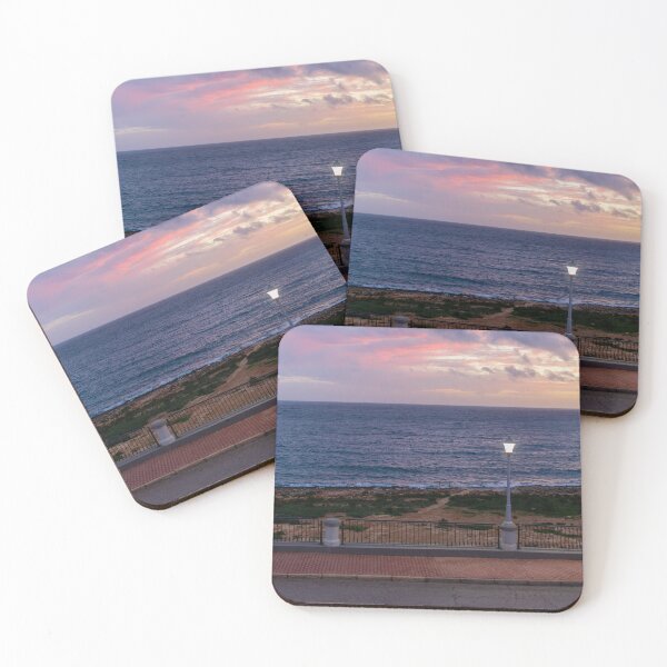 Item preview, Coastal Sunset Over Rocky Shoreline With Lit Lampposts and Distant Headland at Dusk designed and sold by Nmallia.