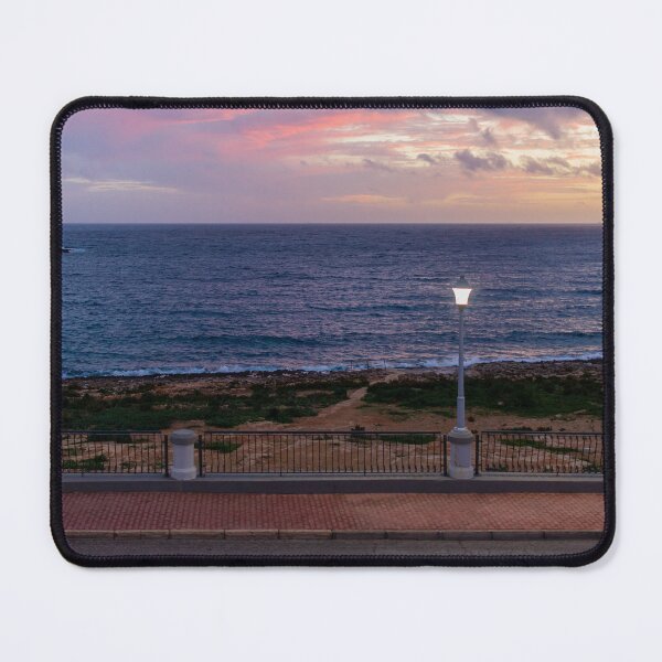 Item preview, Coastal Sunset Over Rocky Shoreline With Lit Lampposts and Distant Headland at Dusk designed and sold by Nmallia.