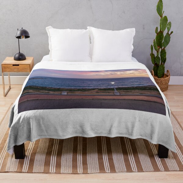 Item preview, Coastal Sunset Over Rocky Shoreline With Lit Lampposts and Distant Headland at Dusk designed and sold by Nmallia.