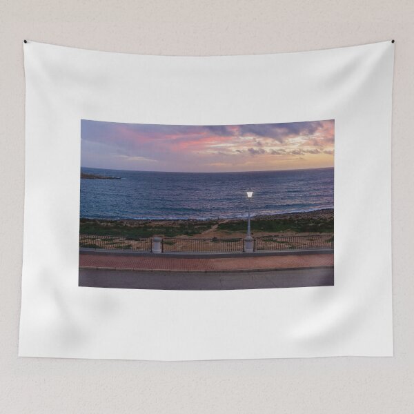 Item preview, Coastal Sunset Over Rocky Shoreline With Lit Lampposts and Distant Headland at Dusk designed and sold by Nmallia.