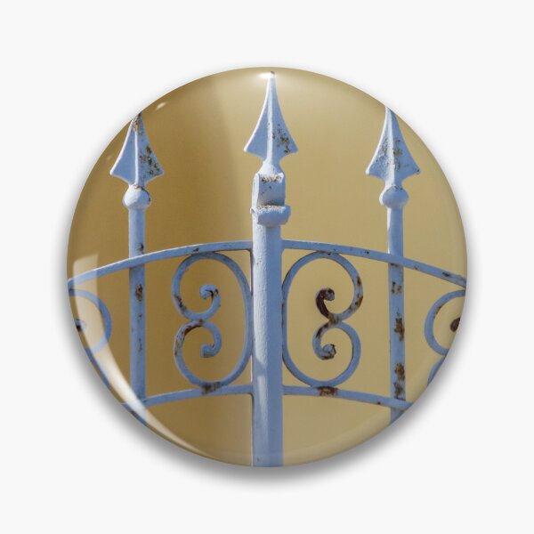 Item preview, Sunlit Ornate Wrought Iron Gate With Rust Patina Against Yellow Wall and Blue Ceramic Planter designed and sold by Nmallia.