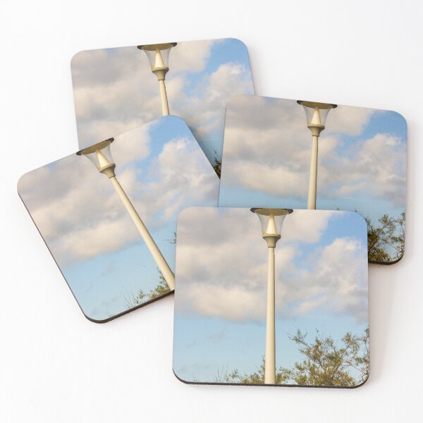 Item preview, Vintage Street Lamp Post Against Blue Sky With Clouds and Tree Branches in Daylight designed and sold by Nmallia.