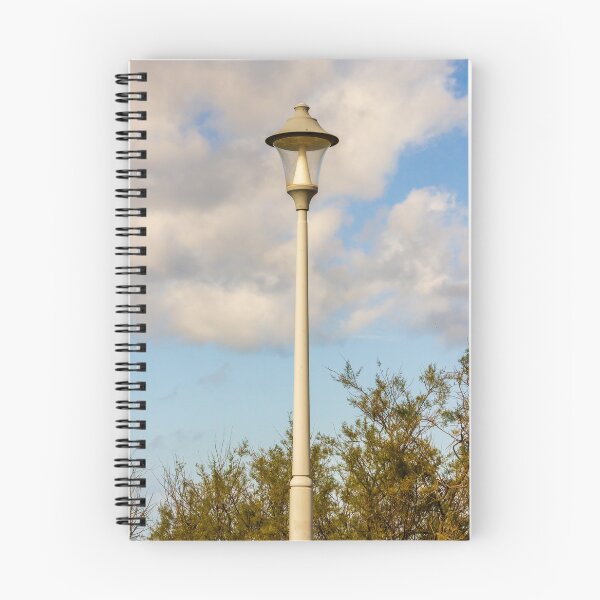 Item preview, Vintage Street Lamp Post Against Blue Sky With Clouds and Tree Branches in Daylight designed and sold by Nmallia.