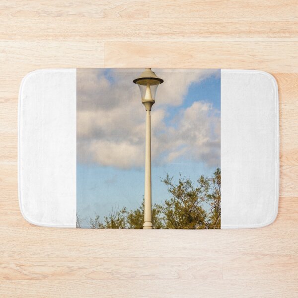 Item preview, Vintage Street Lamp Post Against Blue Sky With Clouds and Tree Branches in Daylight designed and sold by Nmallia.