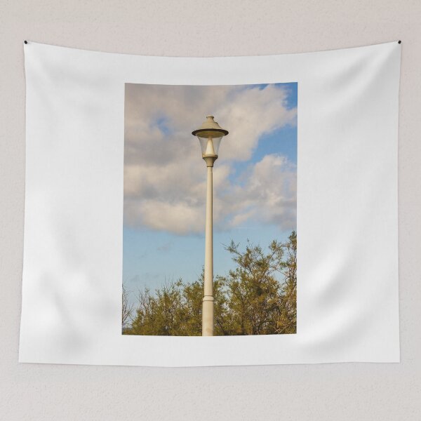 Item preview, Vintage Street Lamp Post Against Blue Sky With Clouds and Tree Branches in Daylight designed and sold by Nmallia.