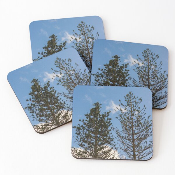 Item preview, Tall Pine Trees Reaching Into A Clear Blue Sky With Scattered White Clouds And Delicate Branches designed and sold by Nmallia.
