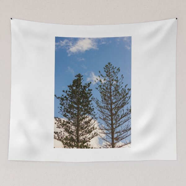 Item preview, Tall Pine Trees Reaching Into A Clear Blue Sky With Scattered White Clouds And Delicate Branches designed and sold by Nmallia.