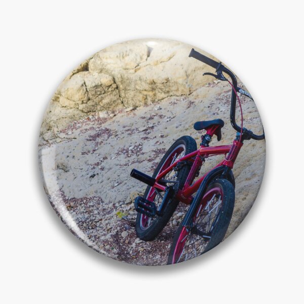 Item preview, Red BMX Bicycle Leaning on Rocky Beach Shoreline Near Sandstone Cliffs on Sunny Day designed and sold by Nmallia.