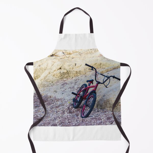 Item preview, Red BMX Bicycle Leaning on Rocky Beach Shoreline Near Sandstone Cliffs on Sunny Day designed and sold by Nmallia.