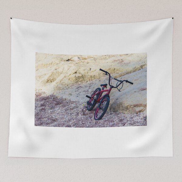Item preview, Red BMX Bicycle Leaning on Rocky Beach Shoreline Near Sandstone Cliffs on Sunny Day designed and sold by Nmallia.