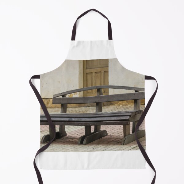 Item preview, Empty Wooden Bench on Quiet Street Pavement Near Old Doorway in Rustic Urban Courtyard designed and sold by Nmallia.