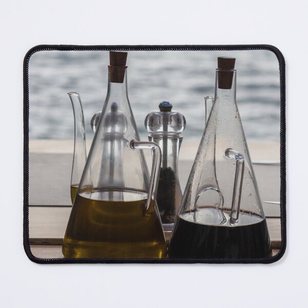 Item preview, Glass Oil And Vinegar Bottles On A Seaside Restaurant Table With Pepper Mill designed and sold by Nmallia.