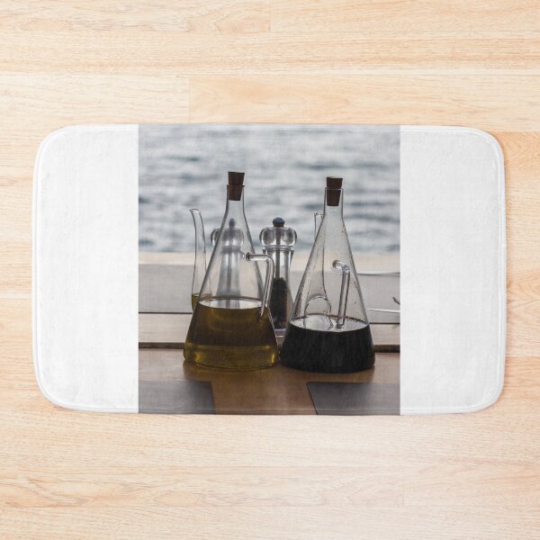 Item preview, Glass Oil And Vinegar Bottles On A Seaside Restaurant Table With Pepper Mill designed and sold by Nmallia.