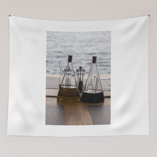 Item preview, Glass Oil And Vinegar Bottles On A Seaside Restaurant Table With Pepper Mill designed and sold by Nmallia.