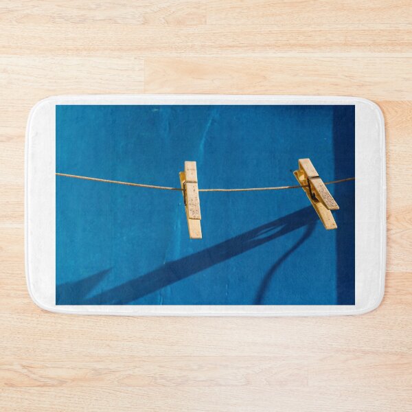 Item preview, Yellow Clothespins On Clothesline Casting Strong Shadows Against Bright Blue Wall Minimal Composition designed and sold by Nmallia.
