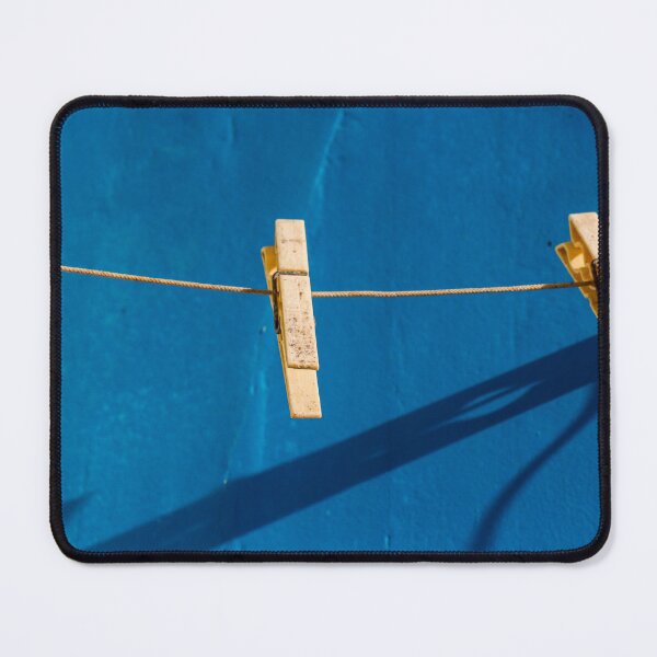 Item preview, Yellow Clothespins On Clothesline Casting Strong Shadows Against Bright Blue Wall Minimal Composition designed and sold by Nmallia.