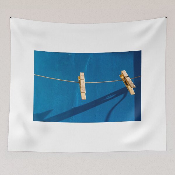 Item preview, Yellow Clothespins On Clothesline Casting Strong Shadows Against Bright Blue Wall Minimal Composition designed and sold by Nmallia.
