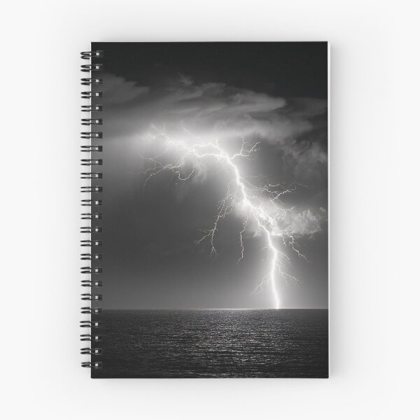 Item preview, Ocean lightning strike fine art photograph of a lightning bolt striking over a dark sea black and white photograph art print designed and sold by Astrid Arkhangelsky.